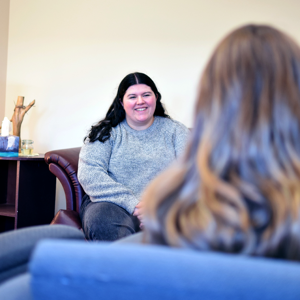 A student smiles while sitting