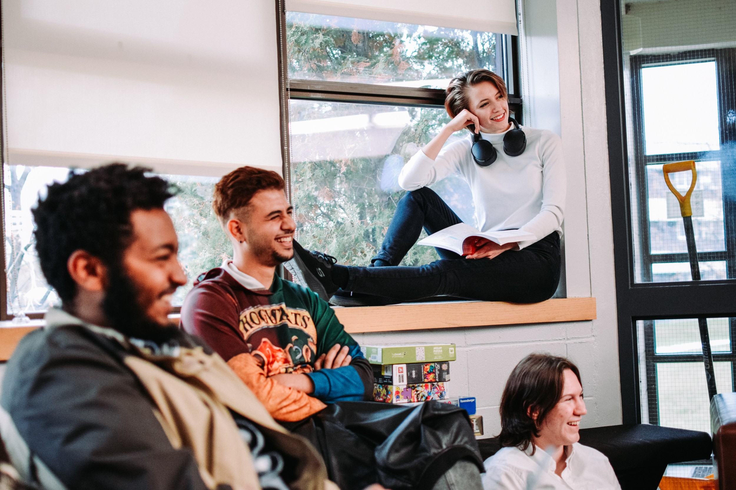 A group of students sit around a residence lounge